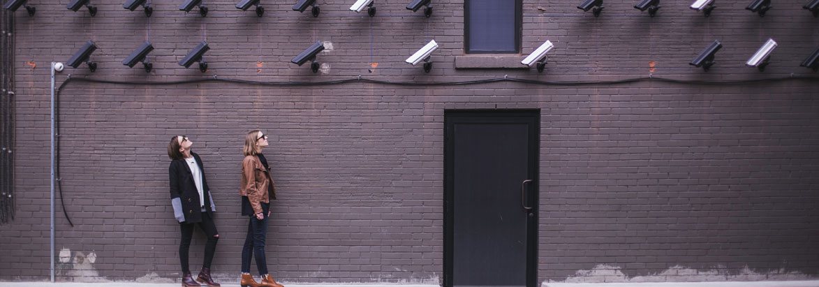Two women looking up at many cameras